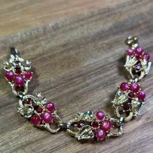 Star signed gold tone pink bracelet